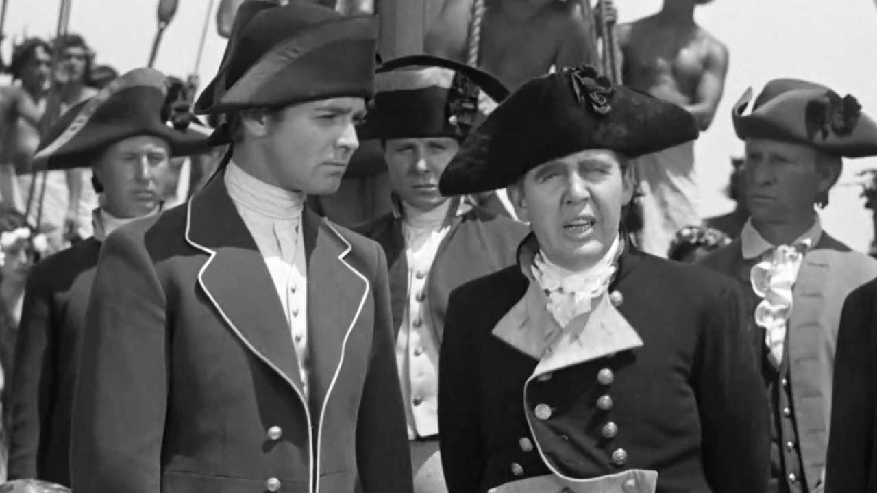 Clark Gable (sem bigode) e Charles Laughton