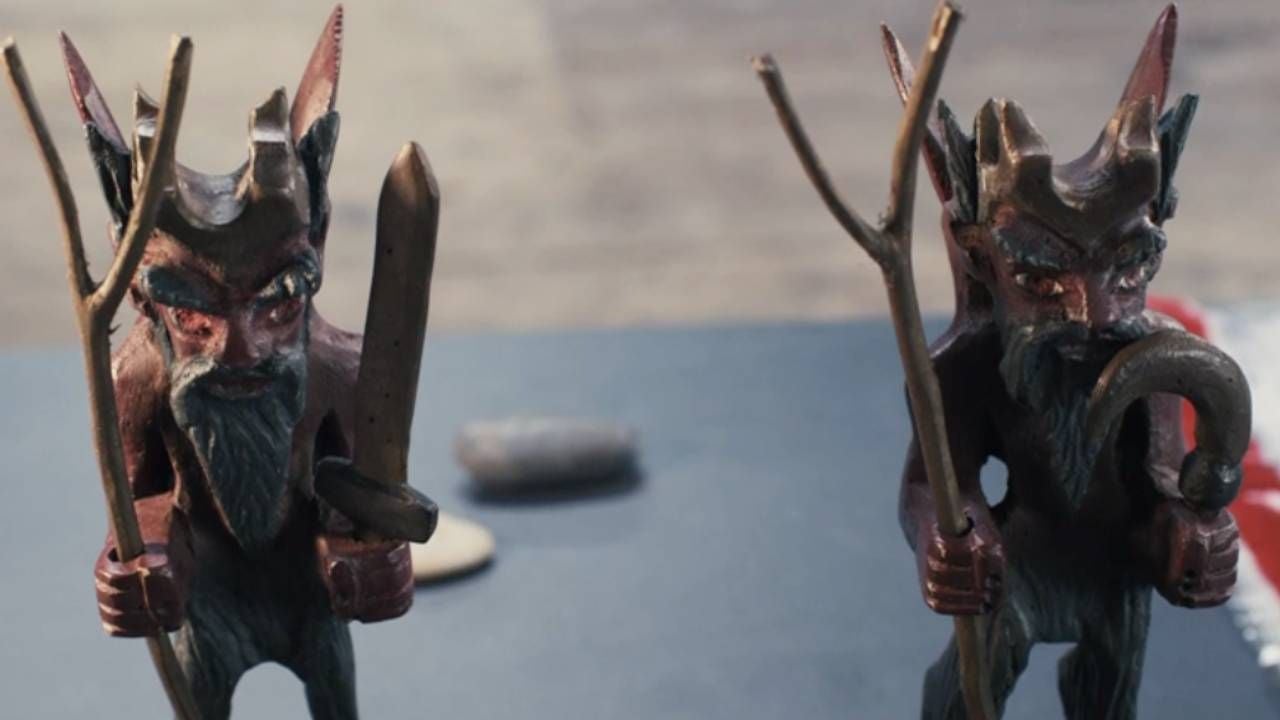 Two statues of the devil found by the police at the scene of the murder.