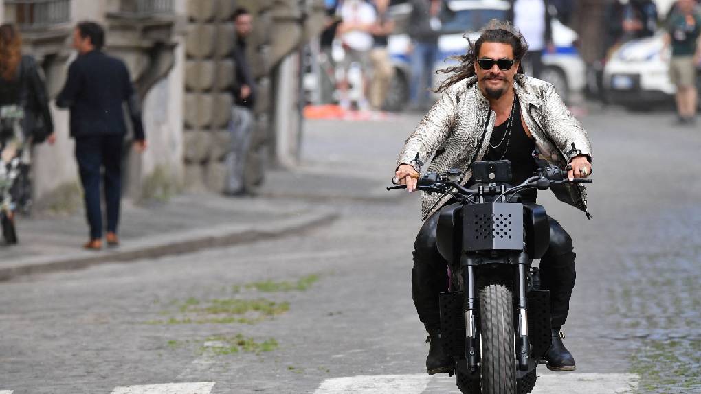 Jason Momoa on a motorcycle through the streets of Rome